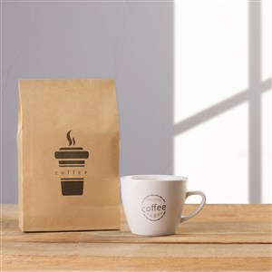 咖啡杯旁边的牛皮纸咖啡豆包装袋贴图样机
